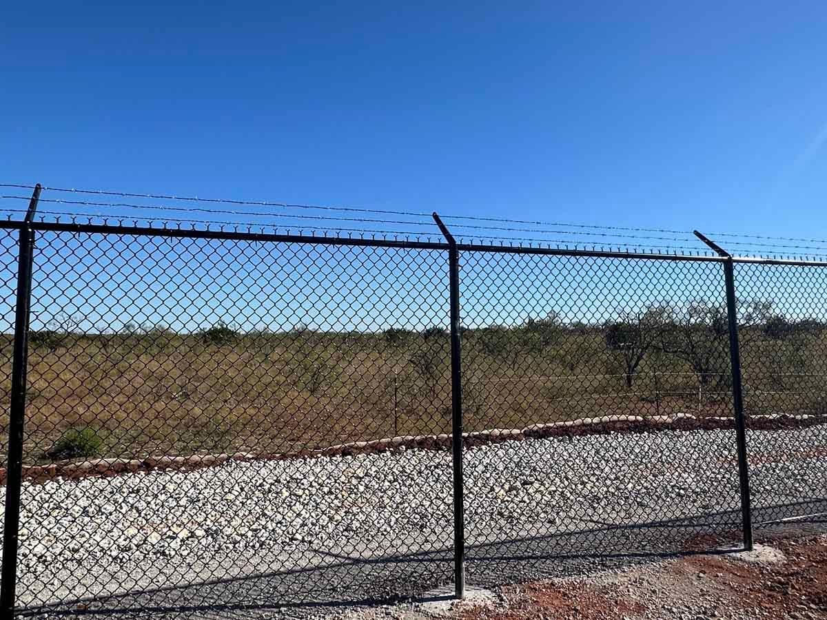 Commercial chain-link fence installation at a DFW industrial property by Postmasters Fencing